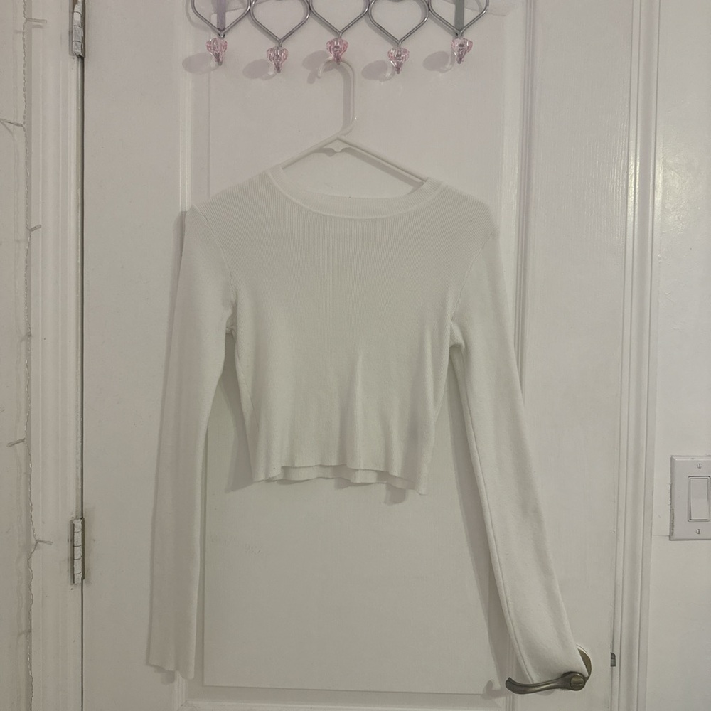Two white long sleeve tops